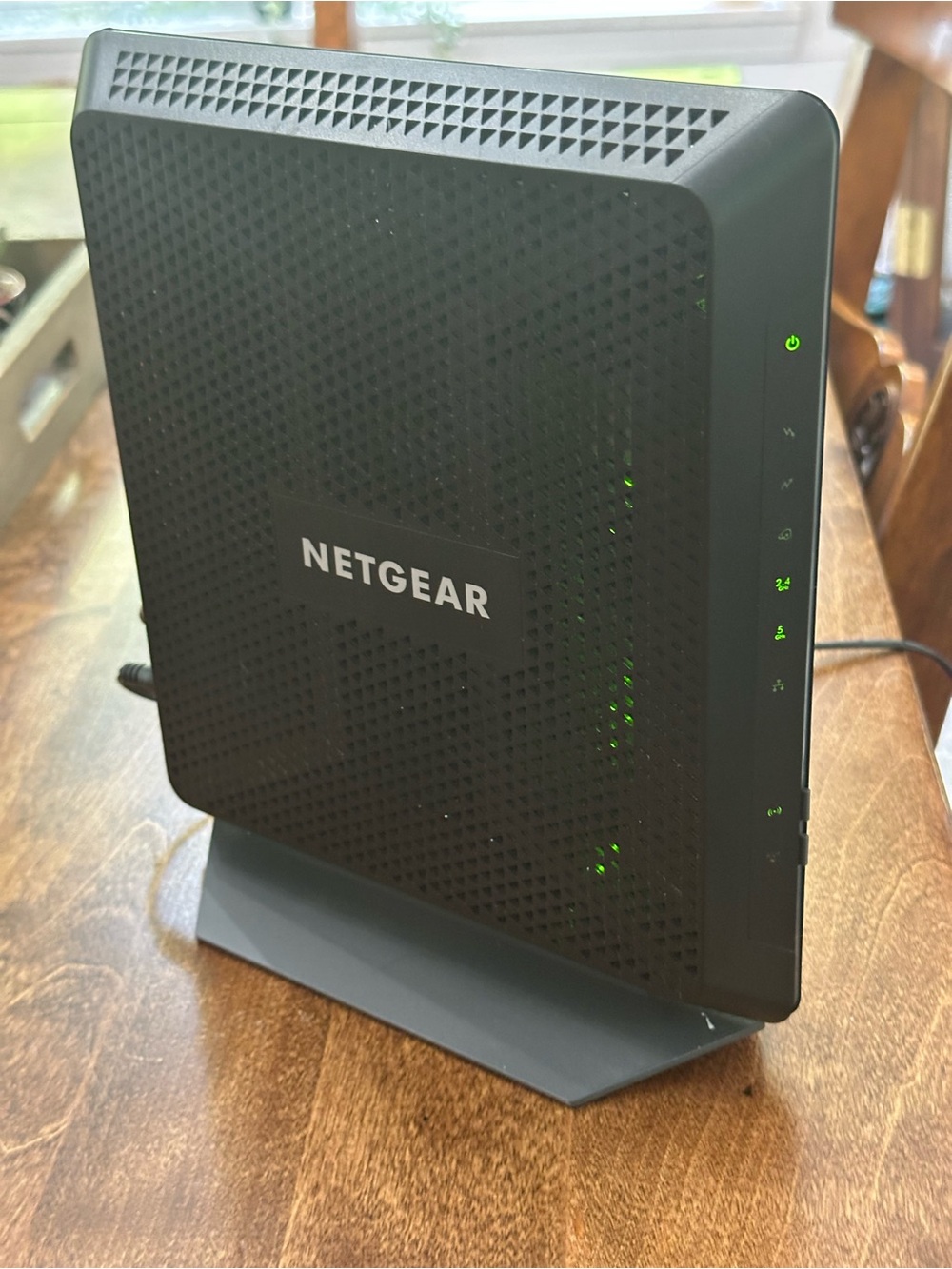 NETGEAR black modem-router with green LED indicators